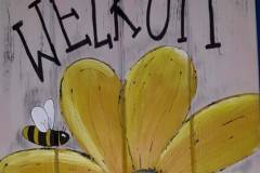 welkomstbord met gele bloem